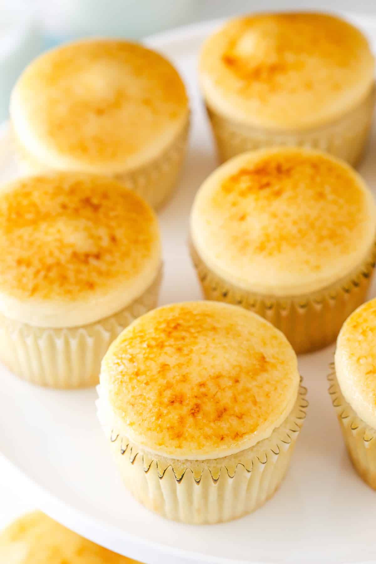 Top view of creme brulee cupcakes on a cake plate.