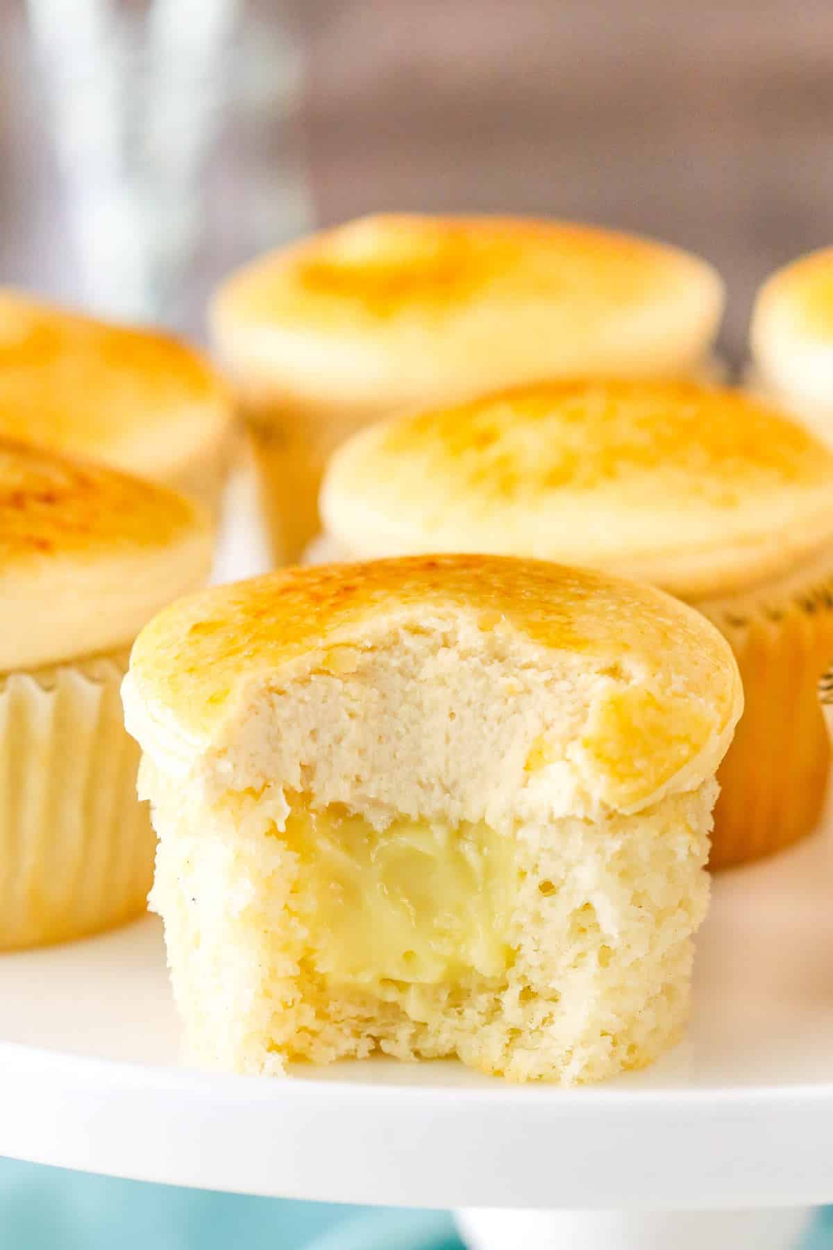 Close up of a creme brulee cupcake with a bite out of it.
