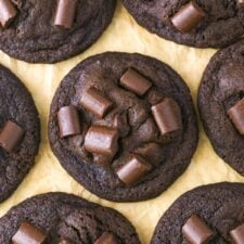Top view of double chocolate chunk cookies on parchment paper.