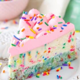 A slice of funfetti cheesecake with cake bottom on a white plate.