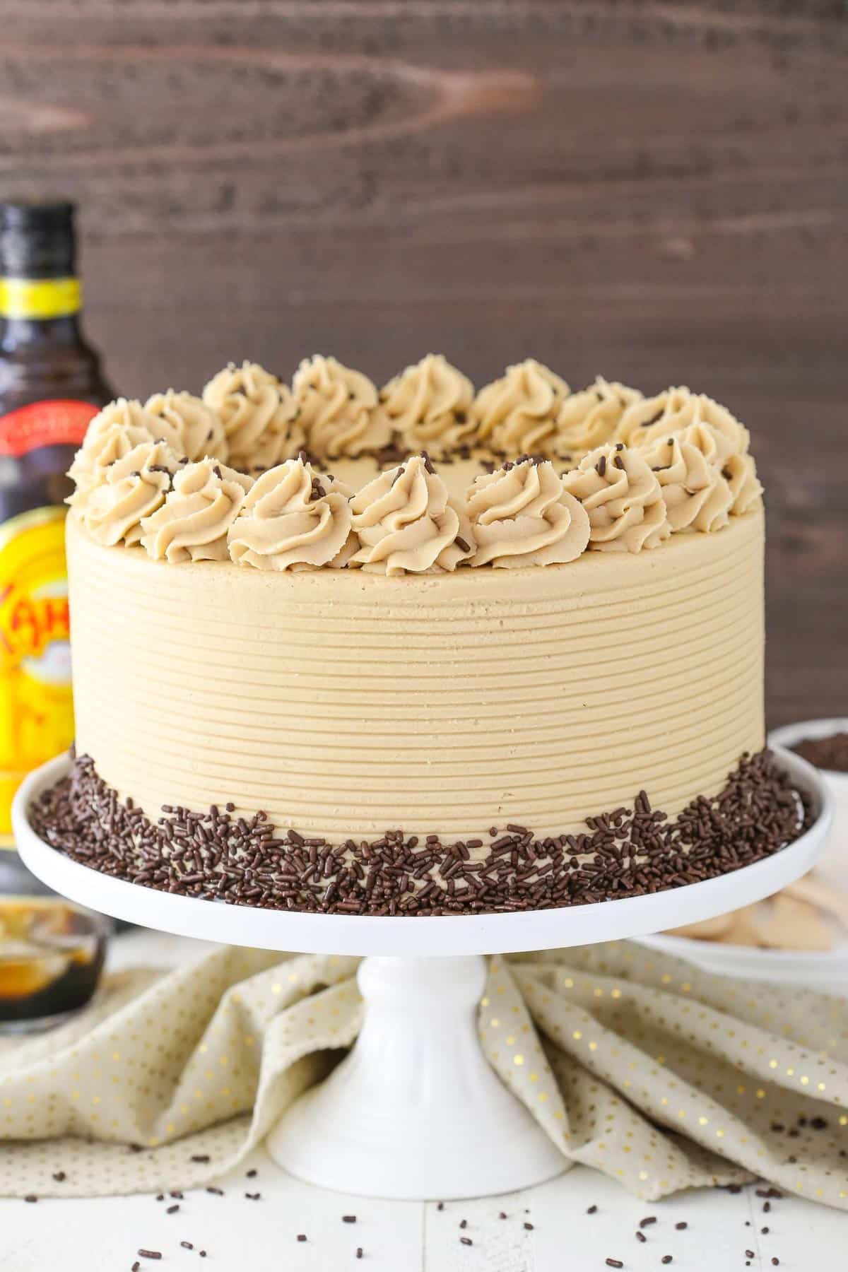 A Kahlua coffee chocolate layer cake on a white cake plate.