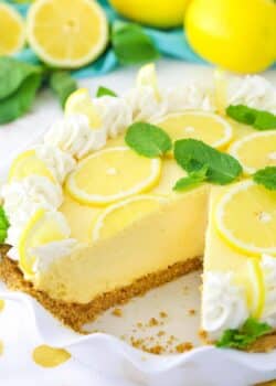 A lemon mascarpone cream pie with a slice missing in a ruffled pie plate.
