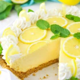 A lemon mascarpone cream pie with a slice missing in a ruffled pie plate.