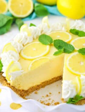 A lemon mascarpone cream pie with a slice missing in a ruffled pie plate.