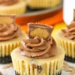 Close up of a mini Reeses peanut butter cheesecake on a piece of parchment paper.