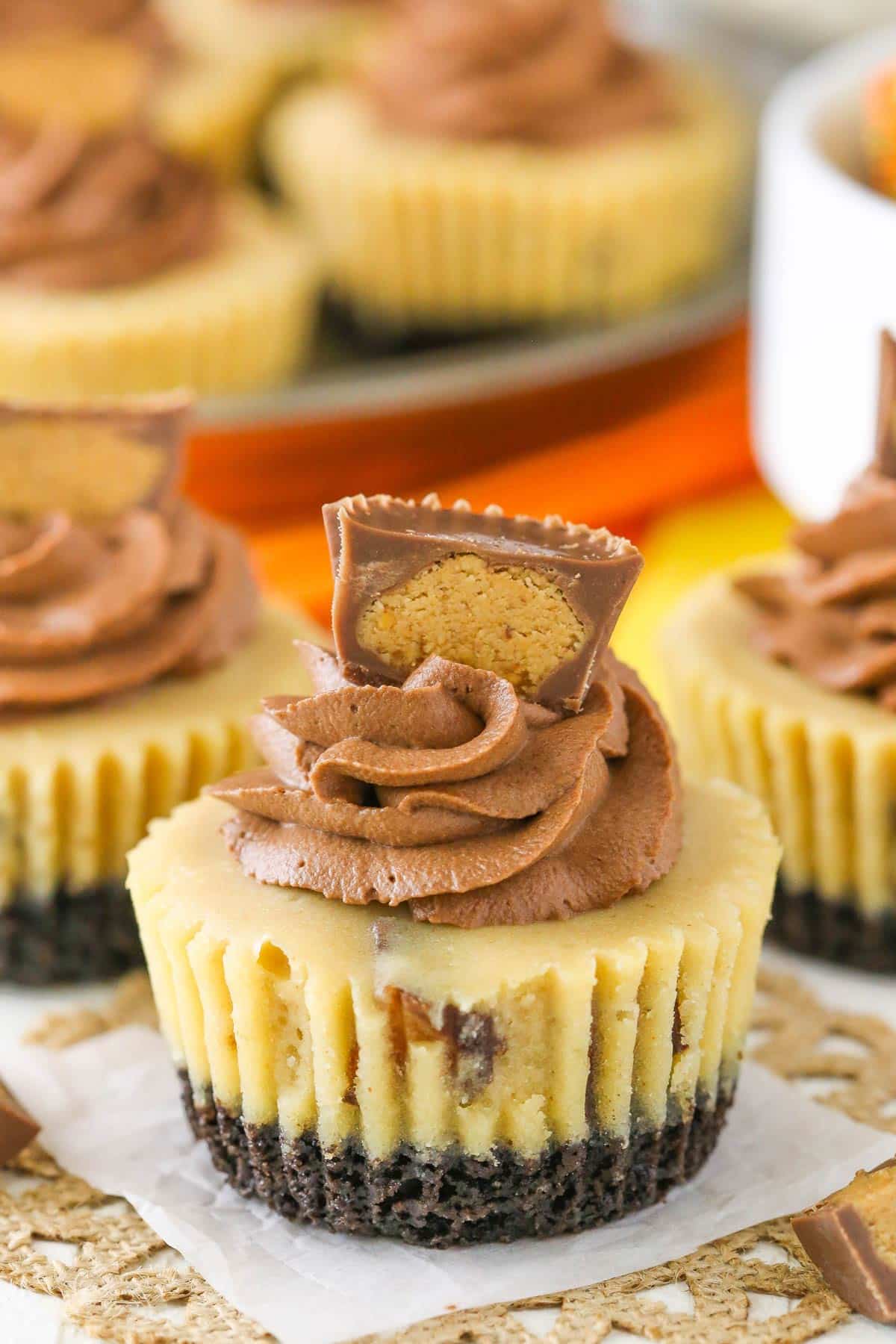 Close up of a mini Reeses peanut butter cheesecake on a piece of parchment paper.