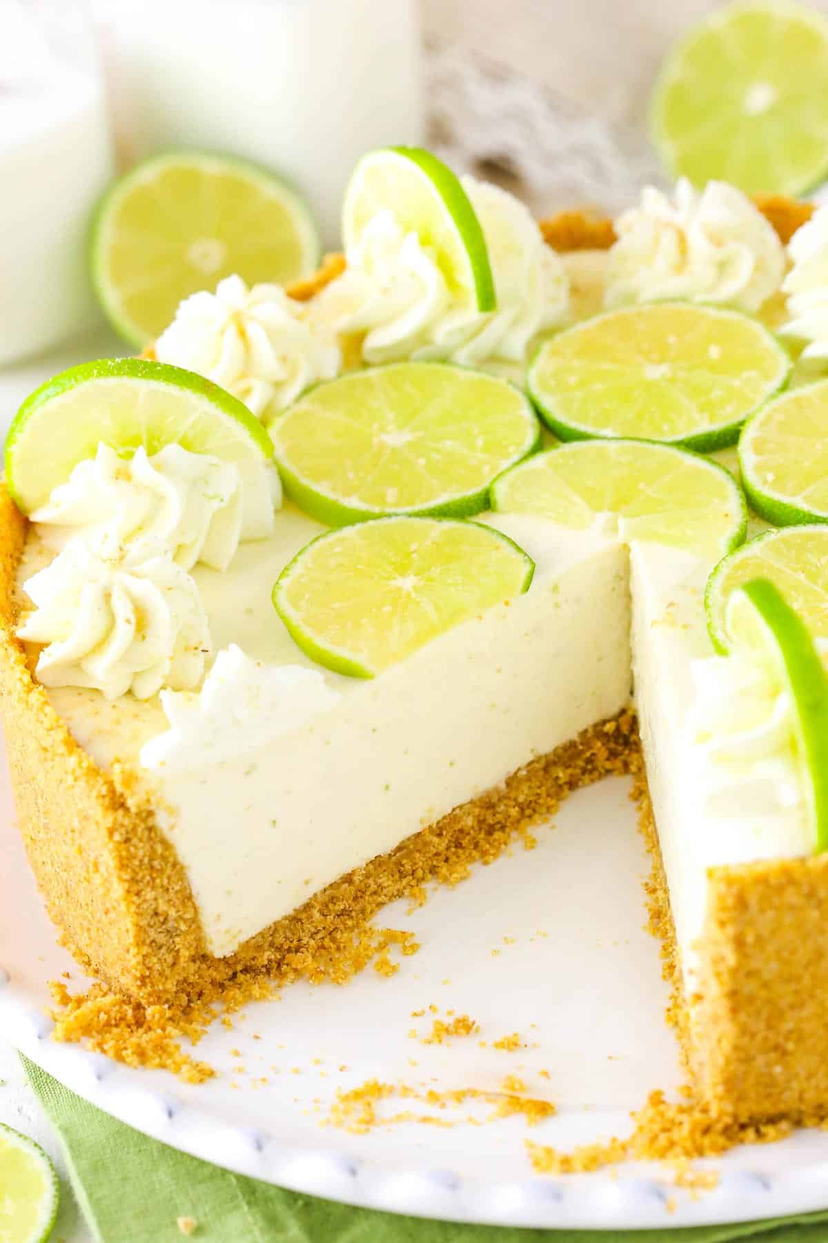 A no bake key lime cheesecake with a slice removed to show interior.