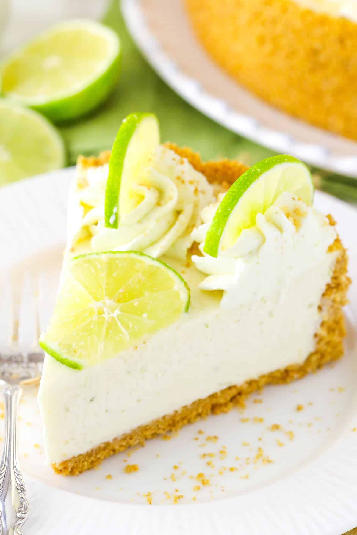 A slice of no bake key lime cheesecake on a white plate.