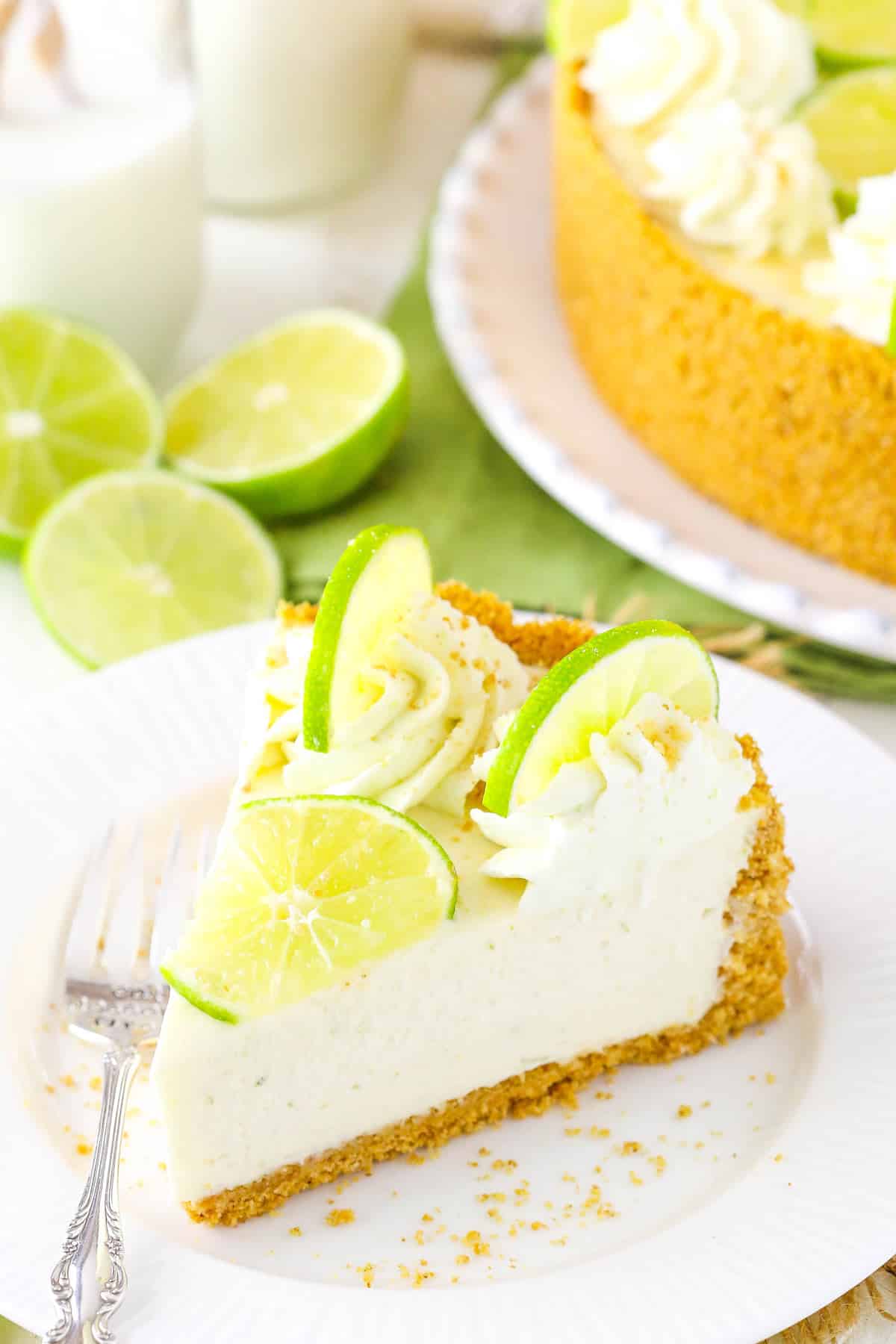 A slice of no bake key lime cheesecake on a white plate.