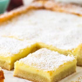 A slice of ooey gooey butter cake cut away from the rest.