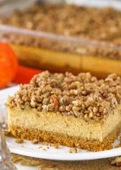Close up of a slice of pecan streusel pumpkin cheesecake.
