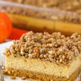 Close up of a slice of pecan streusel pumpkin cheesecake.