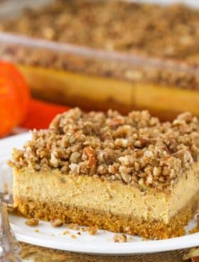 Close up of a slice of pecan streusel pumpkin cheesecake.