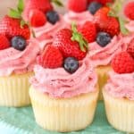 Close up of Berries and Cream Cupcakes on a teal cake stand.