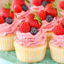 Close up of Berries and Cream Cupcakes on a teal cake stand.