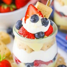 Close up of a berry custard trifle in a jar.