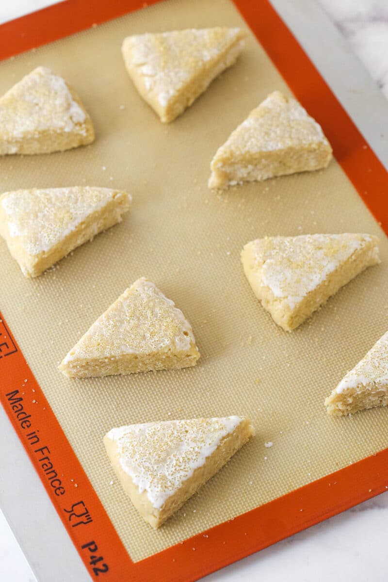 Plain unbaked scones on a silicon mat.