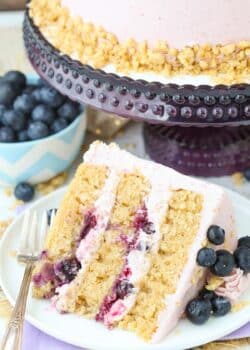 A slice of Blueberry Crumble Layer Cake on a white plate.