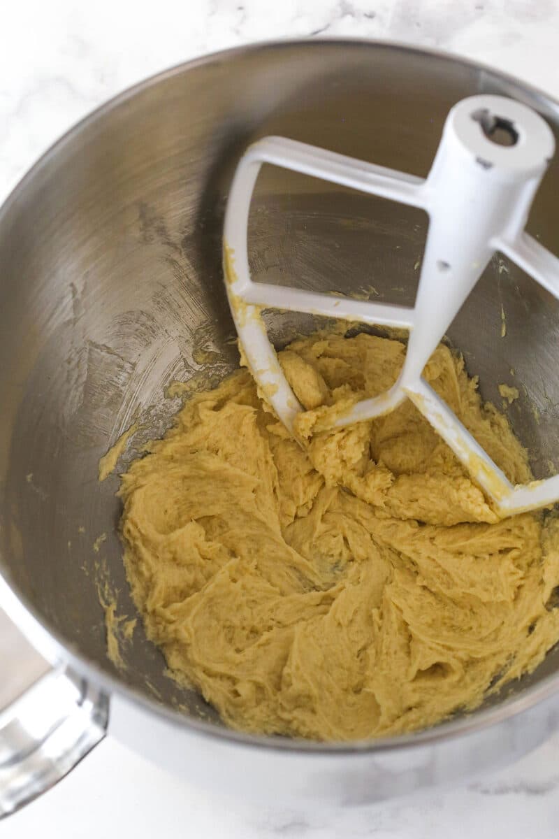 Mixing egg and vanilla into cookie dough.