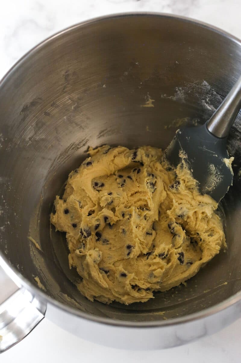 Folding chocolate chips into cookie dough.