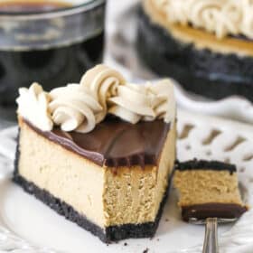 A slice of coffee cheesecake on a plate with a bite taken out of it.