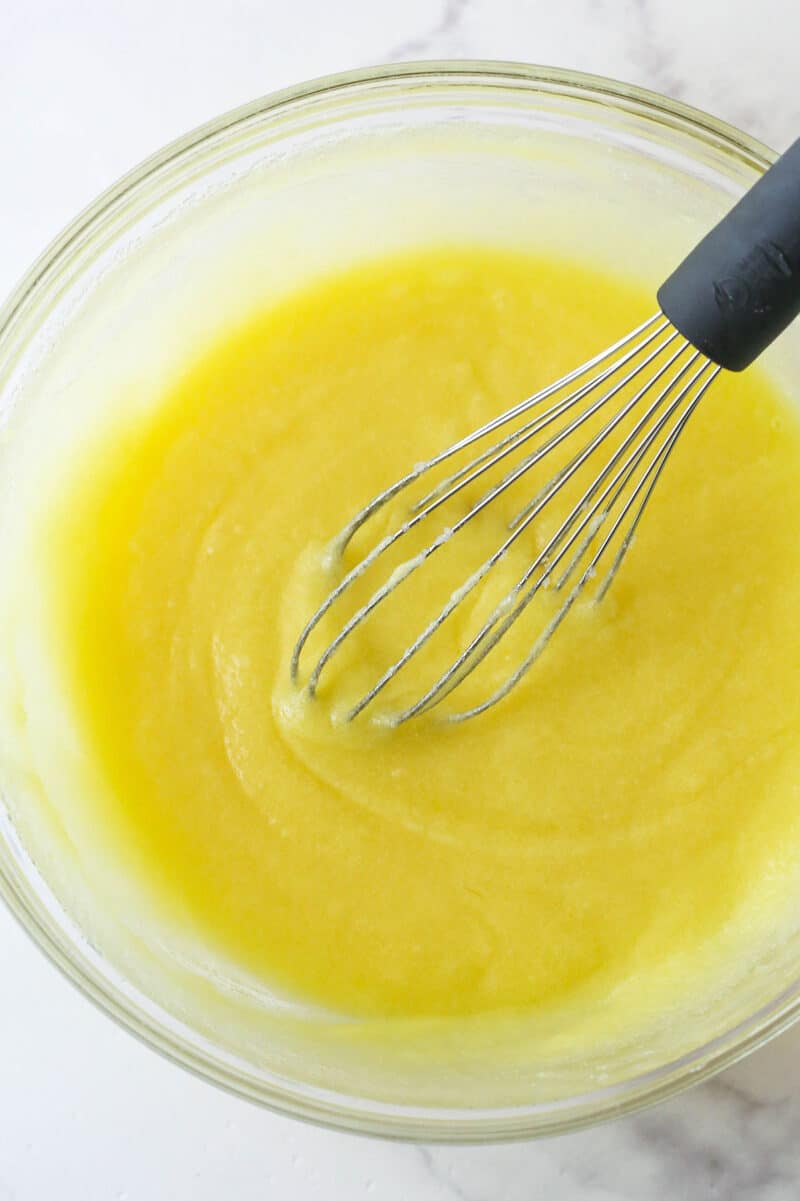 These nostalgia-filled, from-scratch Cosmic Brownies feature a fudgy brownie base topped with silky ganache and colorful sprinkles. Whisking eggs and vanilla into sugar and melted butter.