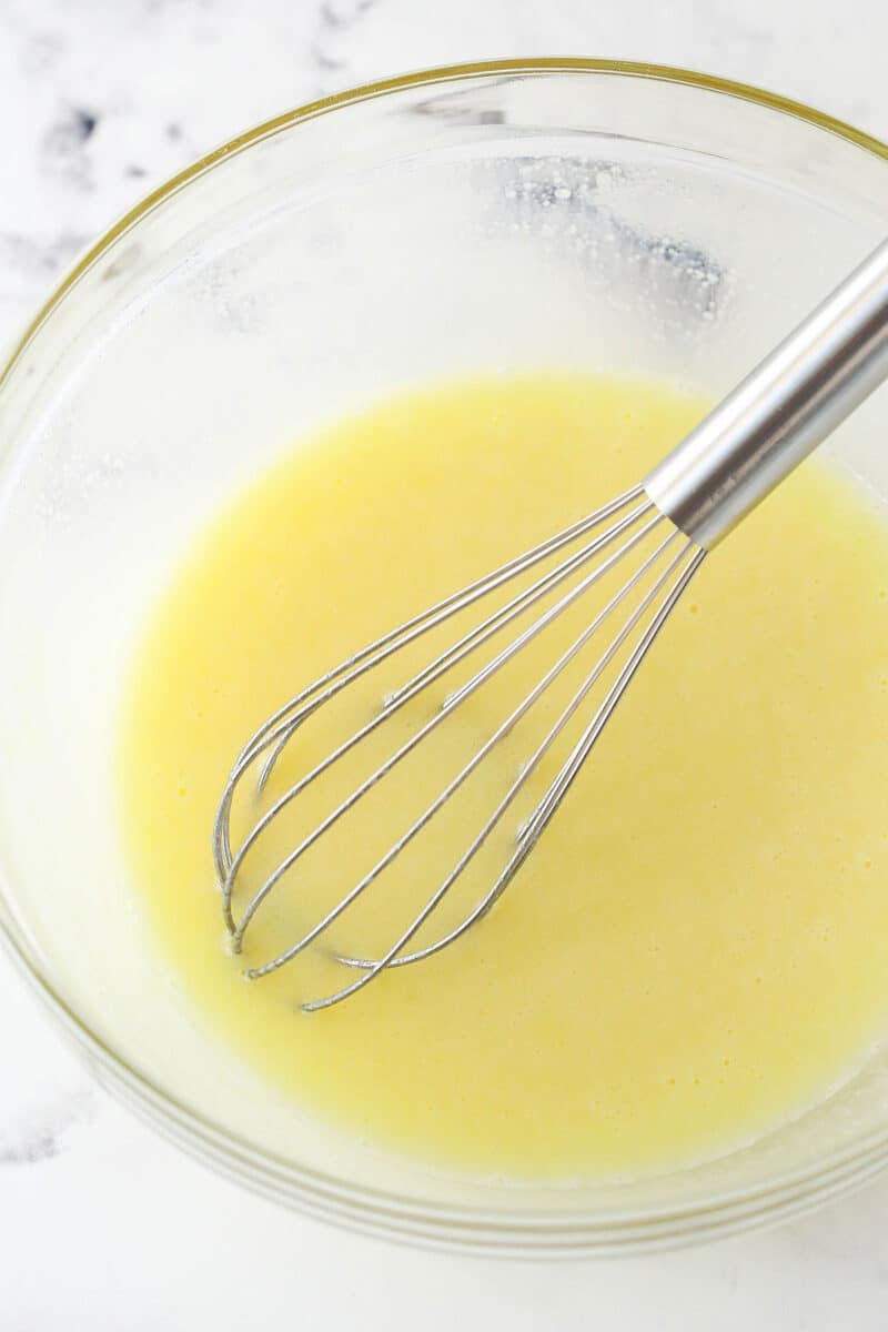 Mixing together butter, oil, sugar, and vanilla, followed by egg and milk.