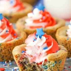 Close up of a patriotic chocolate chip cookie cup with a bite out of it.