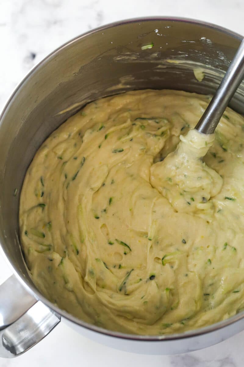 Folding shredded zucchini into lemon cake batter.