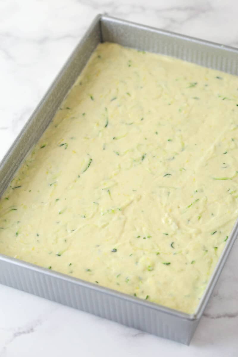 Batter for lemon zucchini cake in a baking pan, ready to go in the oven.
