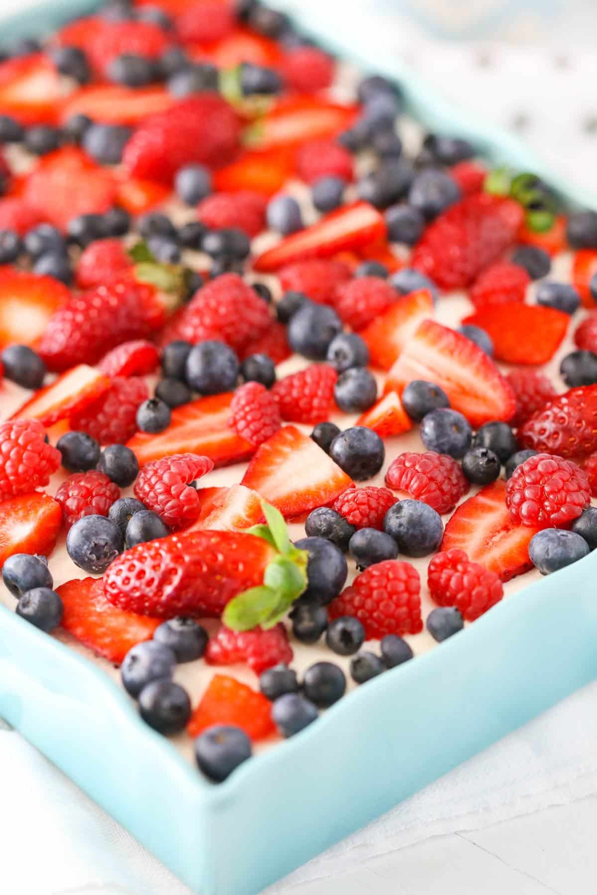 Close up of a pan of berries and cream layer dessert.