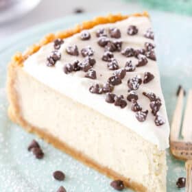 A slice of cannoli cheesecake on a light blue plate.