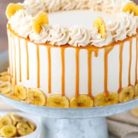 Close up of a Caramel Banana Layer Cake on a silver cake stand.