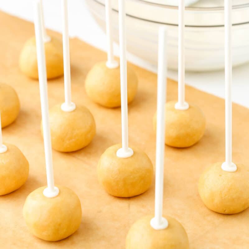 Cookie dough balls with popsicle sticks in them.