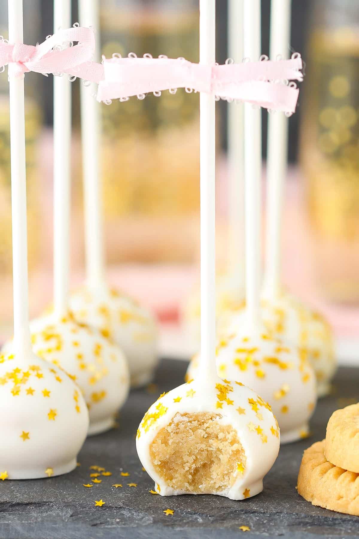 Close up of no bake champagne cookie pops with a bite taken from front pop.
