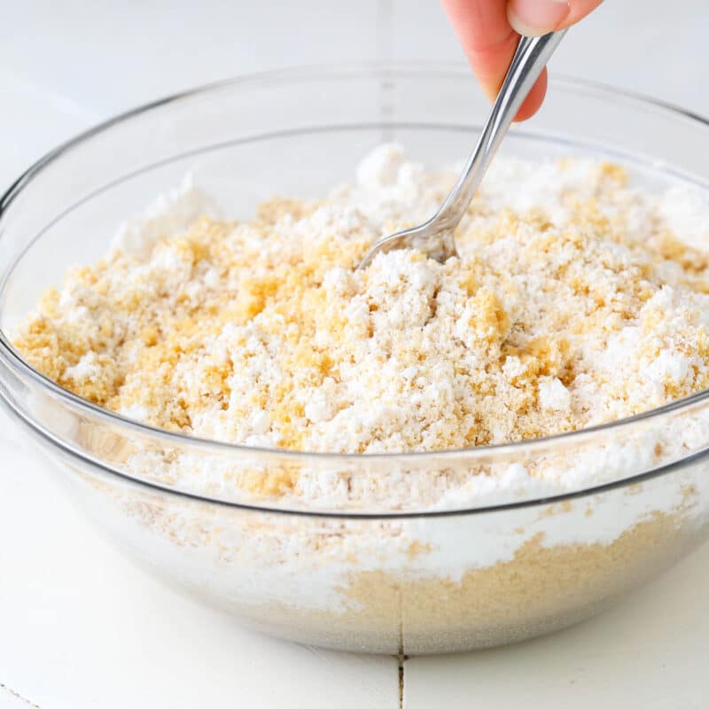 Hand stirring a cookie mixture for no bake champagne cookie pops.