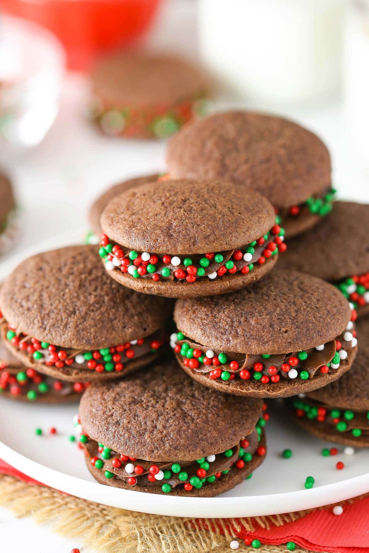 Close up of double chocolate sandwich cookies on a white plate.