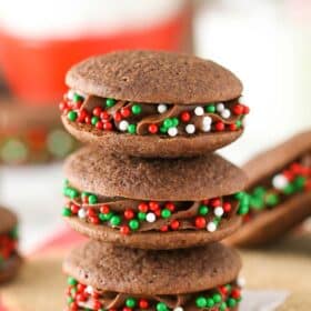 Three double chocolate sandwich cookies stacked one on top of the other.