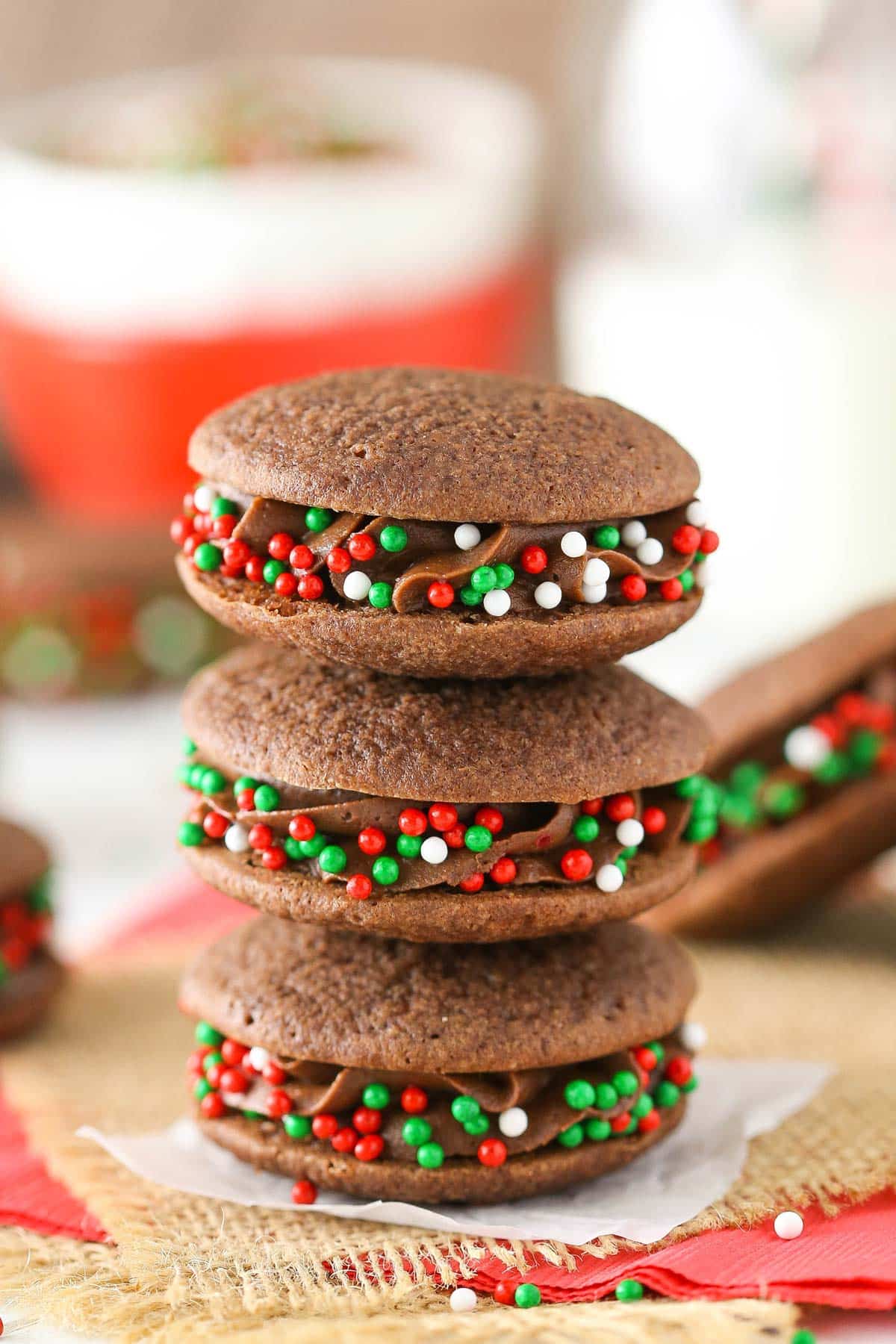 Three double chocolate sandwich cookies stacked one on top of the other.