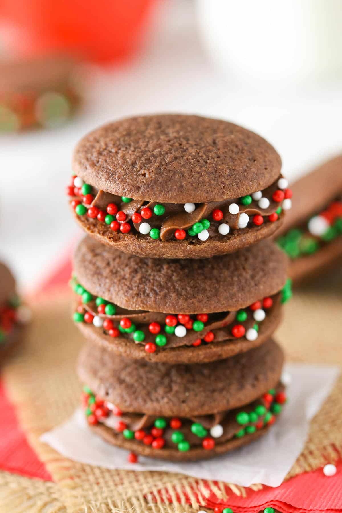 A stack of three double chocolate sandwich cookies.