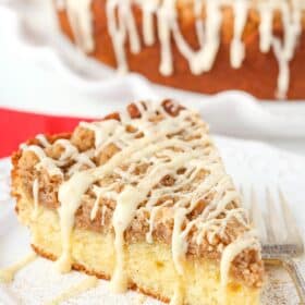 A slice of eggnog crumb cake on a white plate.