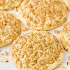Close up of gluten free toffee almond cookies on a white tray.