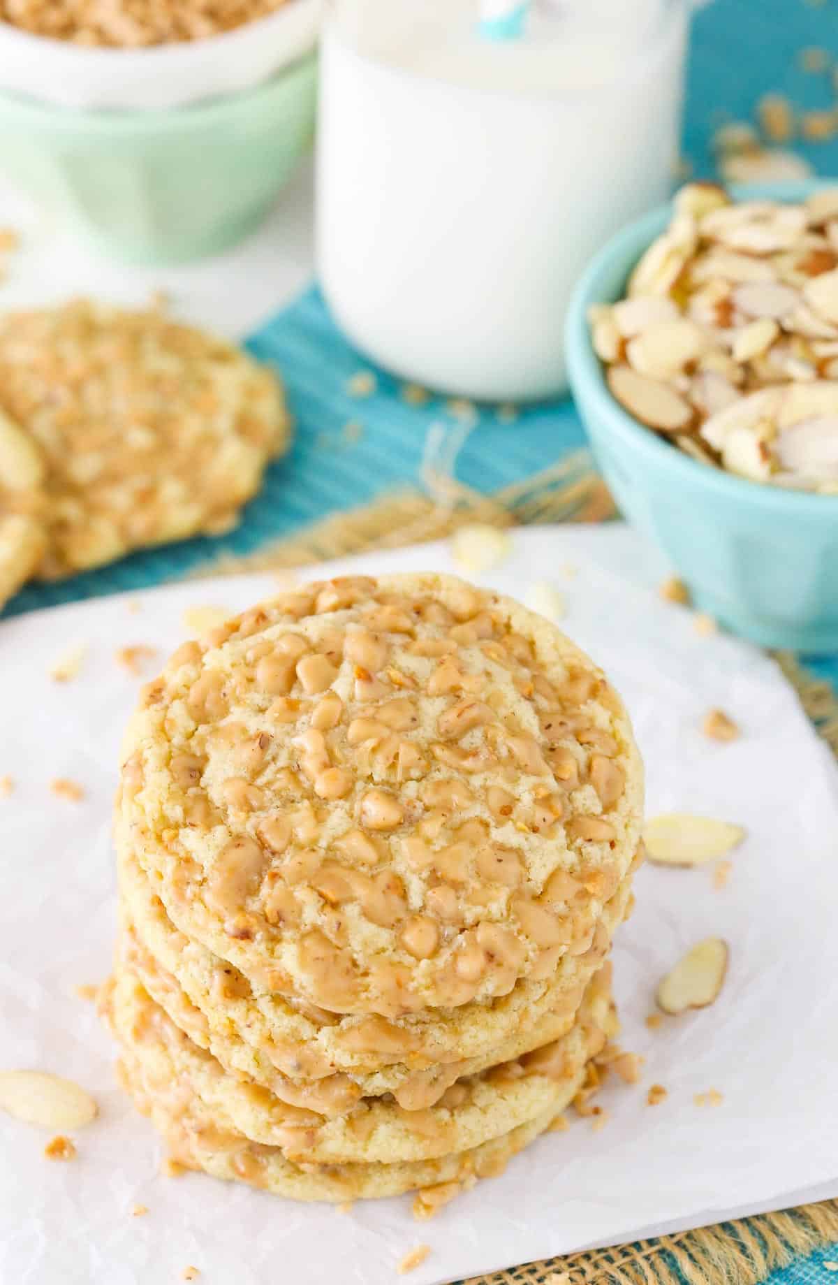 A stack of four gluten free toffee almond cookies on a napkin.