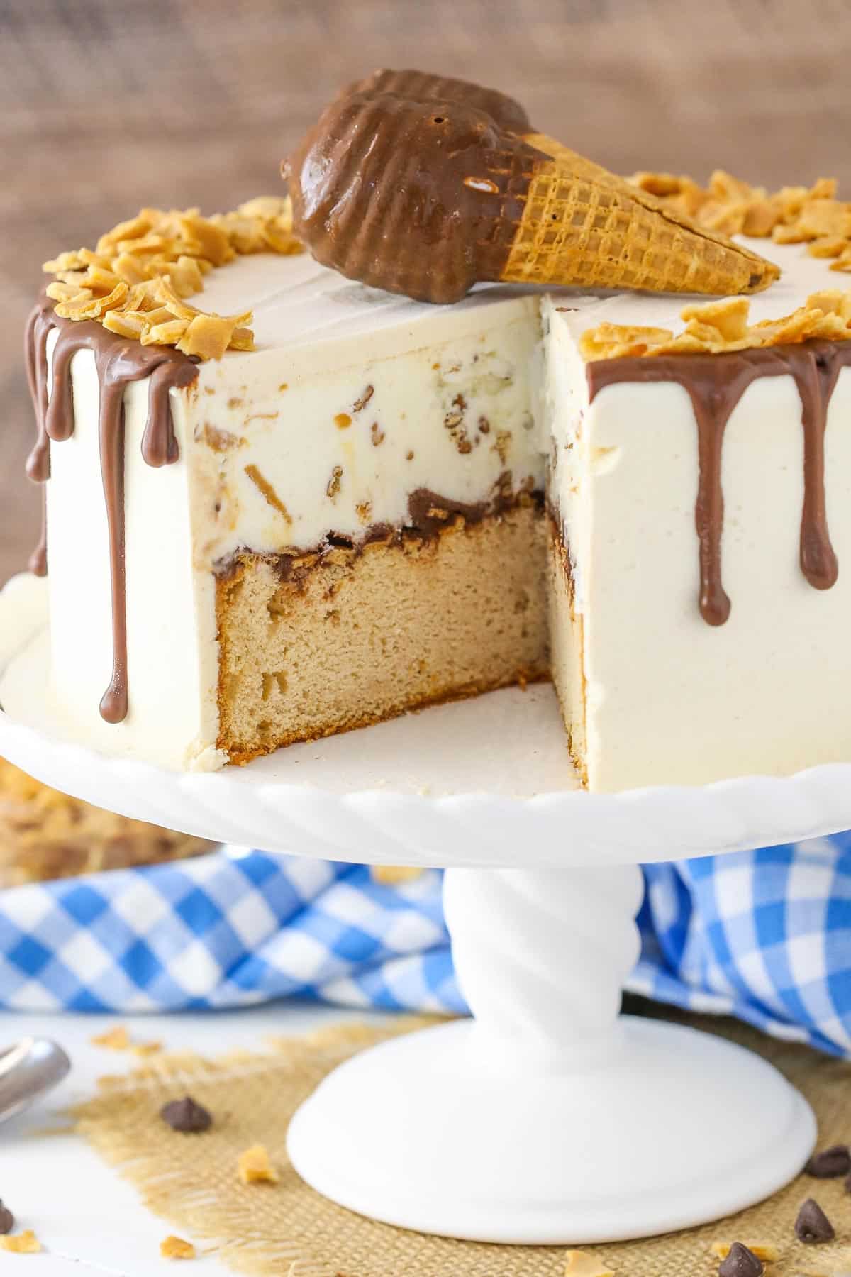 A peanut butter chocolate ice cream cone cake with a slice removed to show interior.