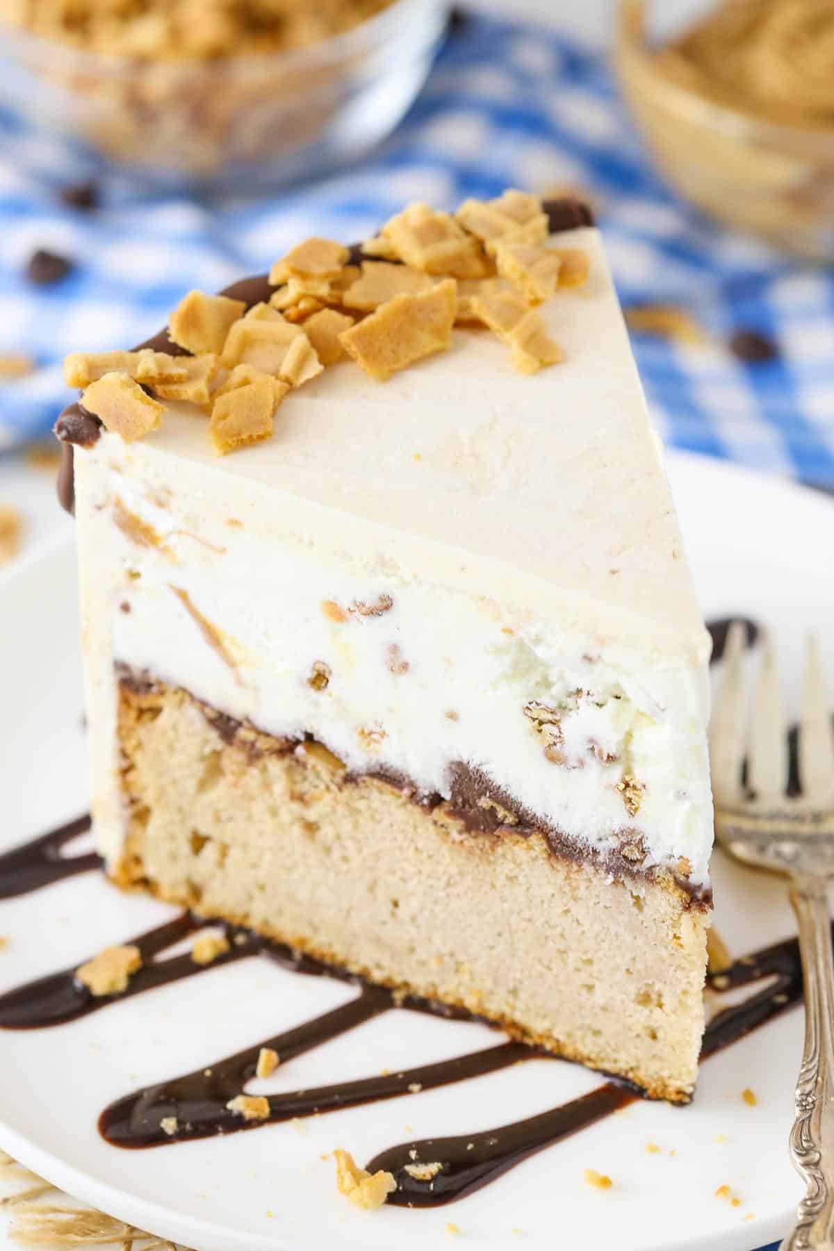 Close up of a slice of peanut butter chocolate ice cream cone cake on a white plate.