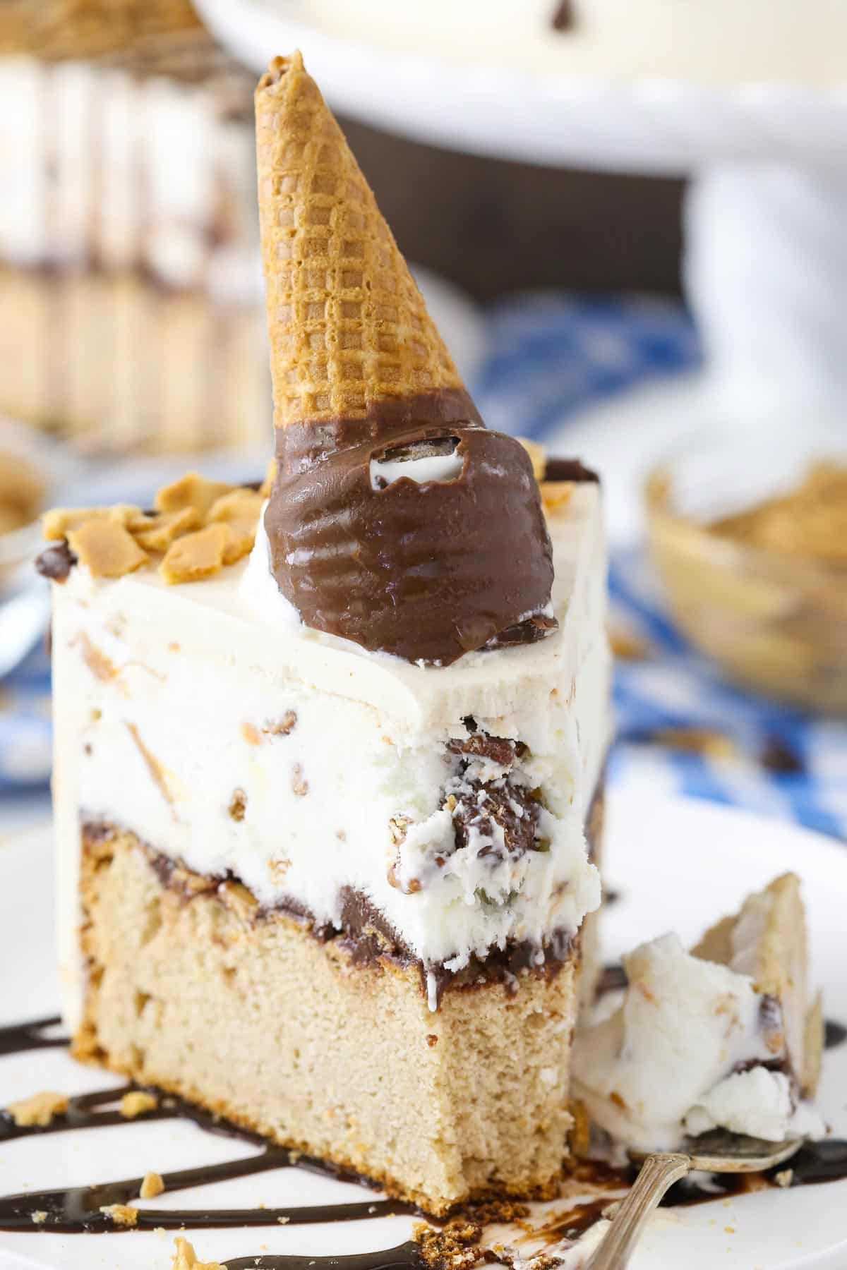 A slice of peanut butter chocolate ice cream cone cake with a bite removed on a fork.