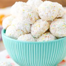 A teal bowl filled with toasted coconut bunny tails.