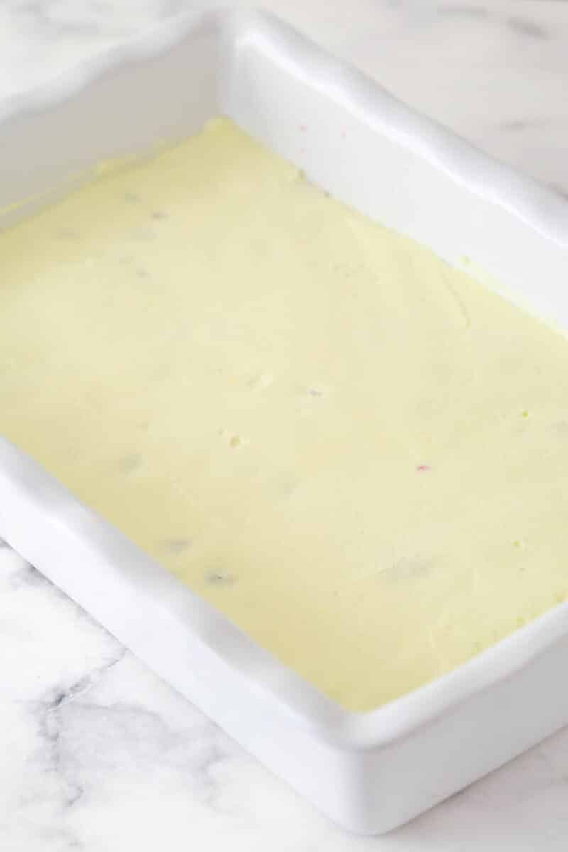 layer of mascarpone filling spread on top of berry layer in pan