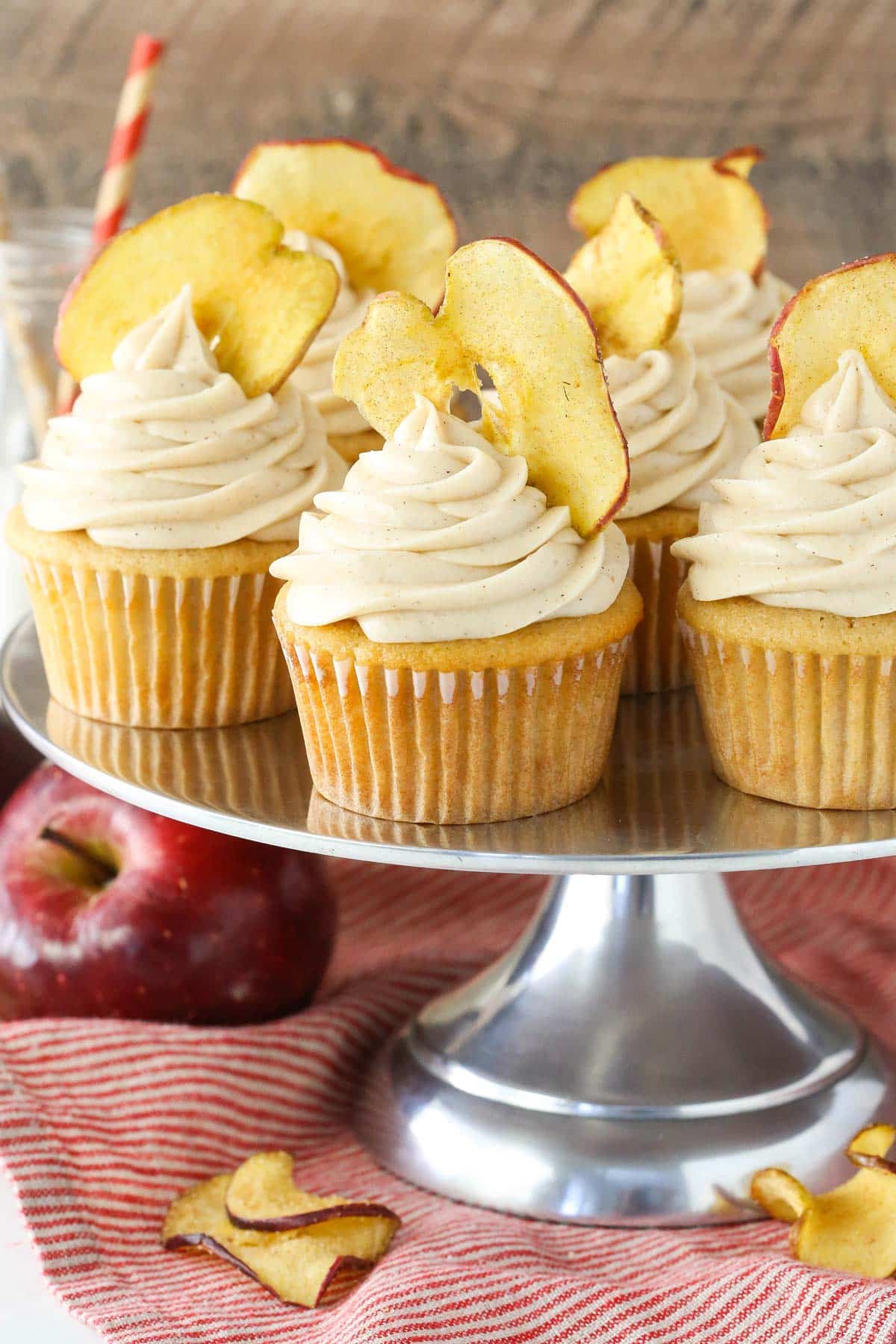 Apple butter cupcakes on a silver cake stand.