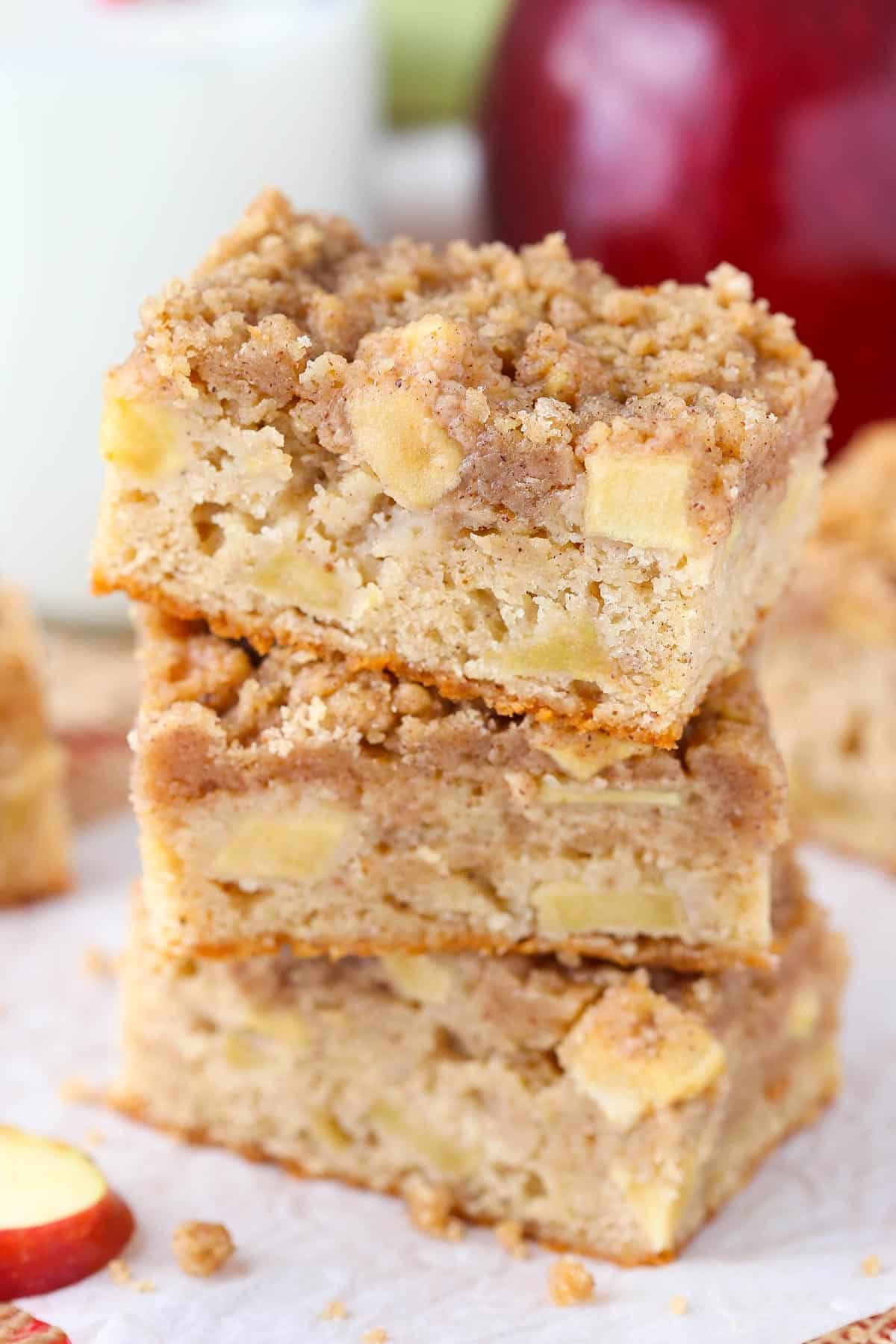 Close up of three apple streusel bars stacked one on top of the other.